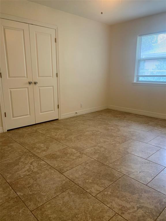 2302 Mesquite Lane, Unit A Georgetown, TX 78628 - Photo 9 of 11 Unfurnished bedroom featuring baseboards and a closet