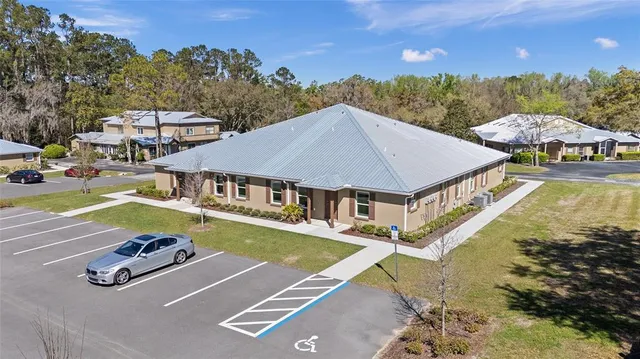 an aerial view of a house with swimming pool patio and outdoor seating