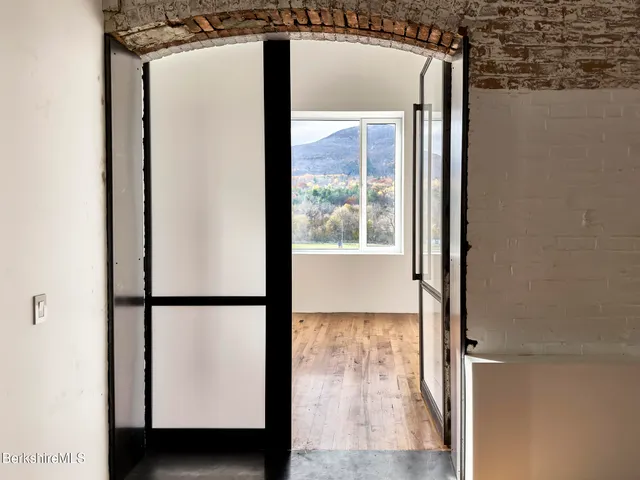 a view of front door with wooden floor