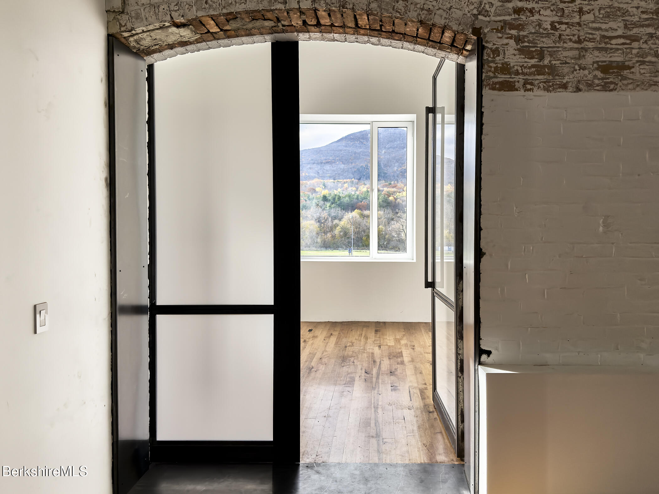 a view of front door with wooden floor