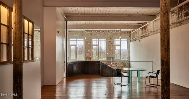 a view of a room with wooden floor and door