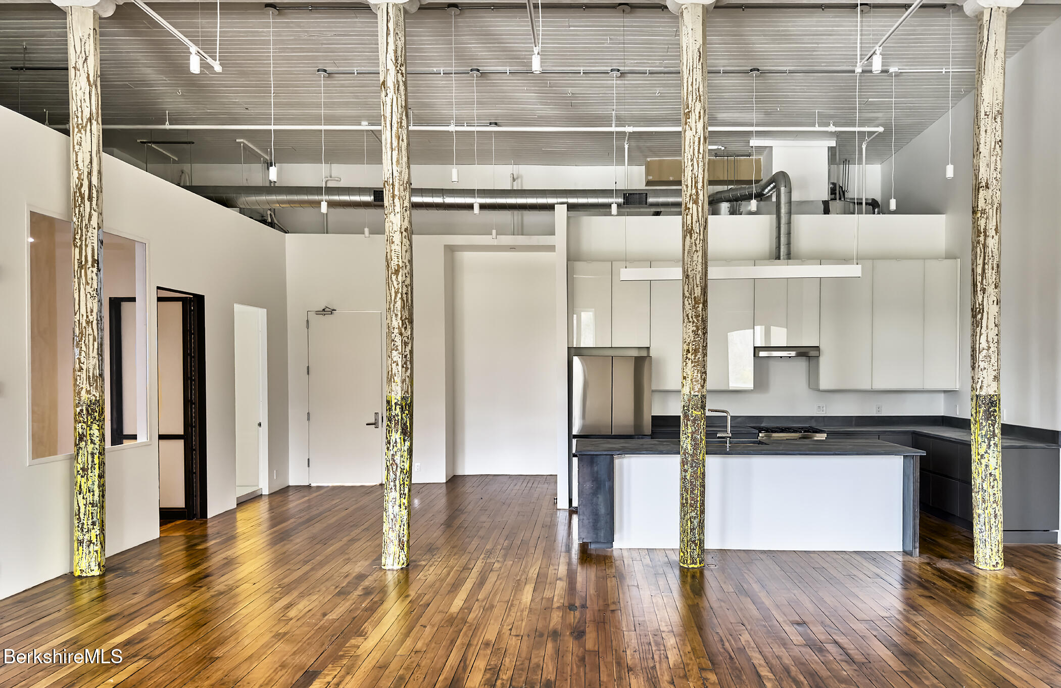 520 State Road, Unit 402 North Adams, MA 01247 - Photo 8 of 22 a kitchen with stainless steel appliances a refrigerator and wooden floor