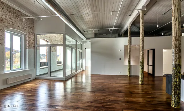 a view of an entryway with wooden floor