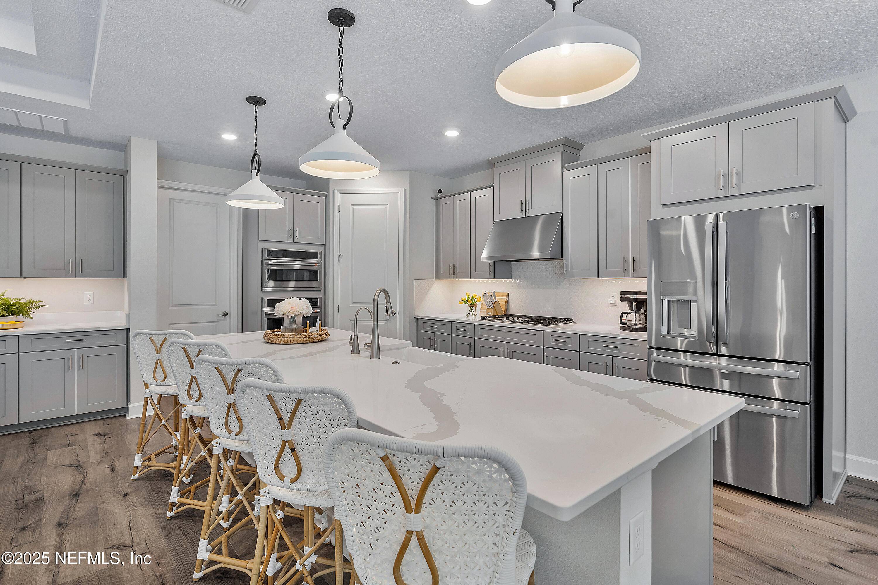 290 Marquesa Circle St. Johns, FL 32259 - Photo 27 of 107 a kitchen with stainless steel appliances granite countertop a sink a stove a refrigerator and island