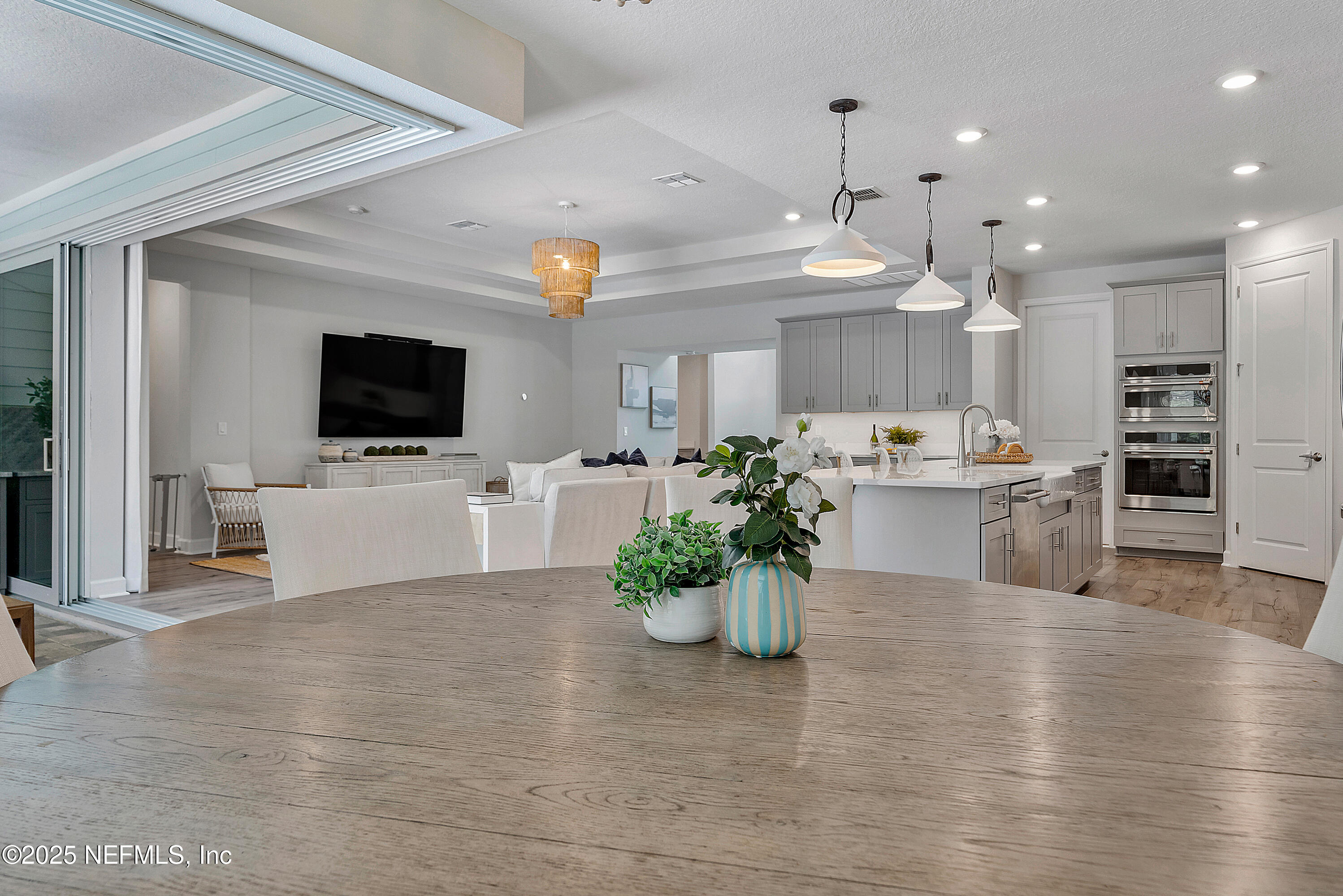 290 Marquesa Circle St. Johns, FL 32259 - Photo 37 of 107 a view of a kitchen with kitchen island a flat screen tv a island and stainless steel appliances