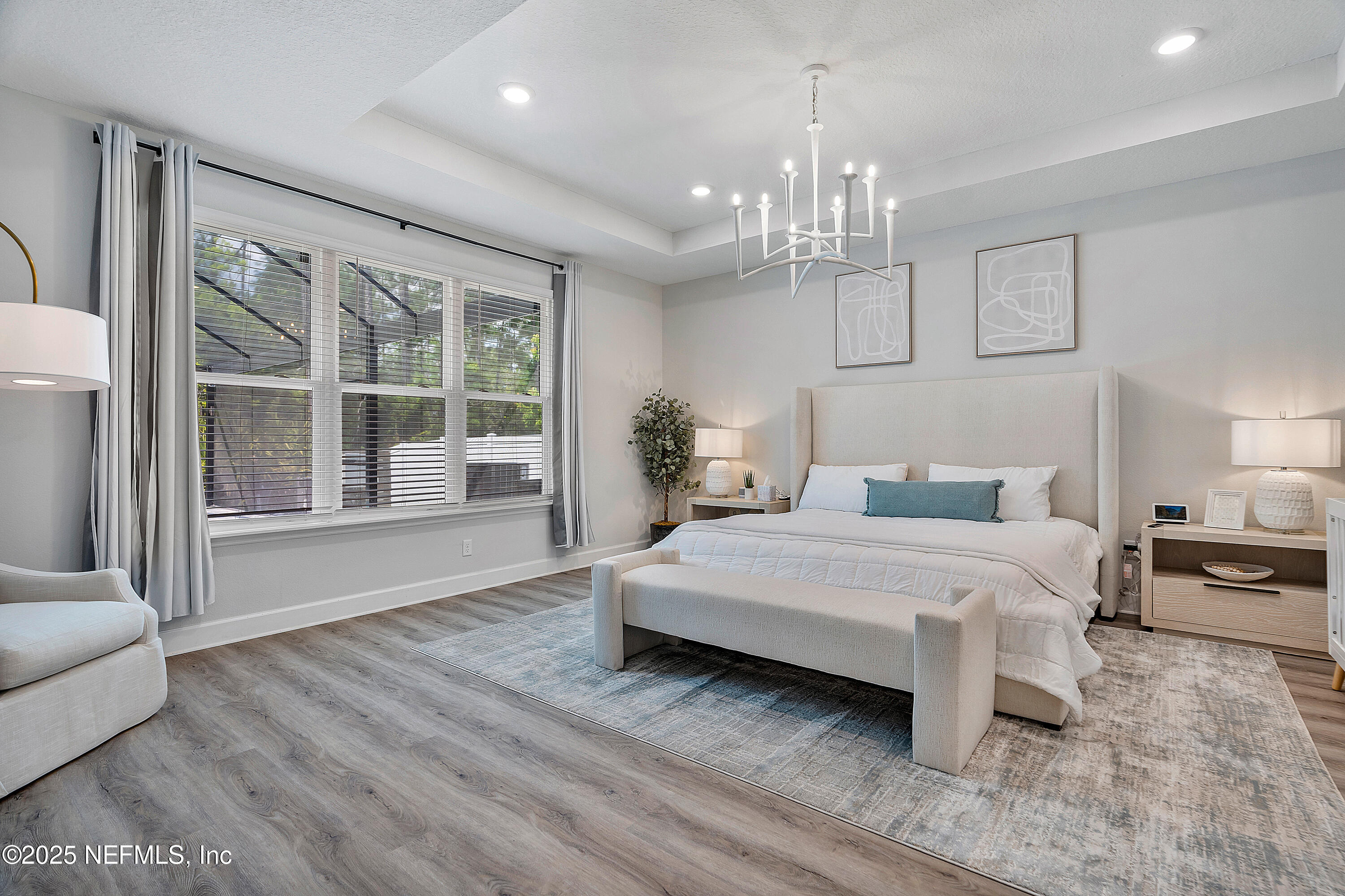 290 Marquesa Circle St. Johns, FL 32259 - Photo 40 of 107 a spacious bedroom with a large bed chandelier and a window