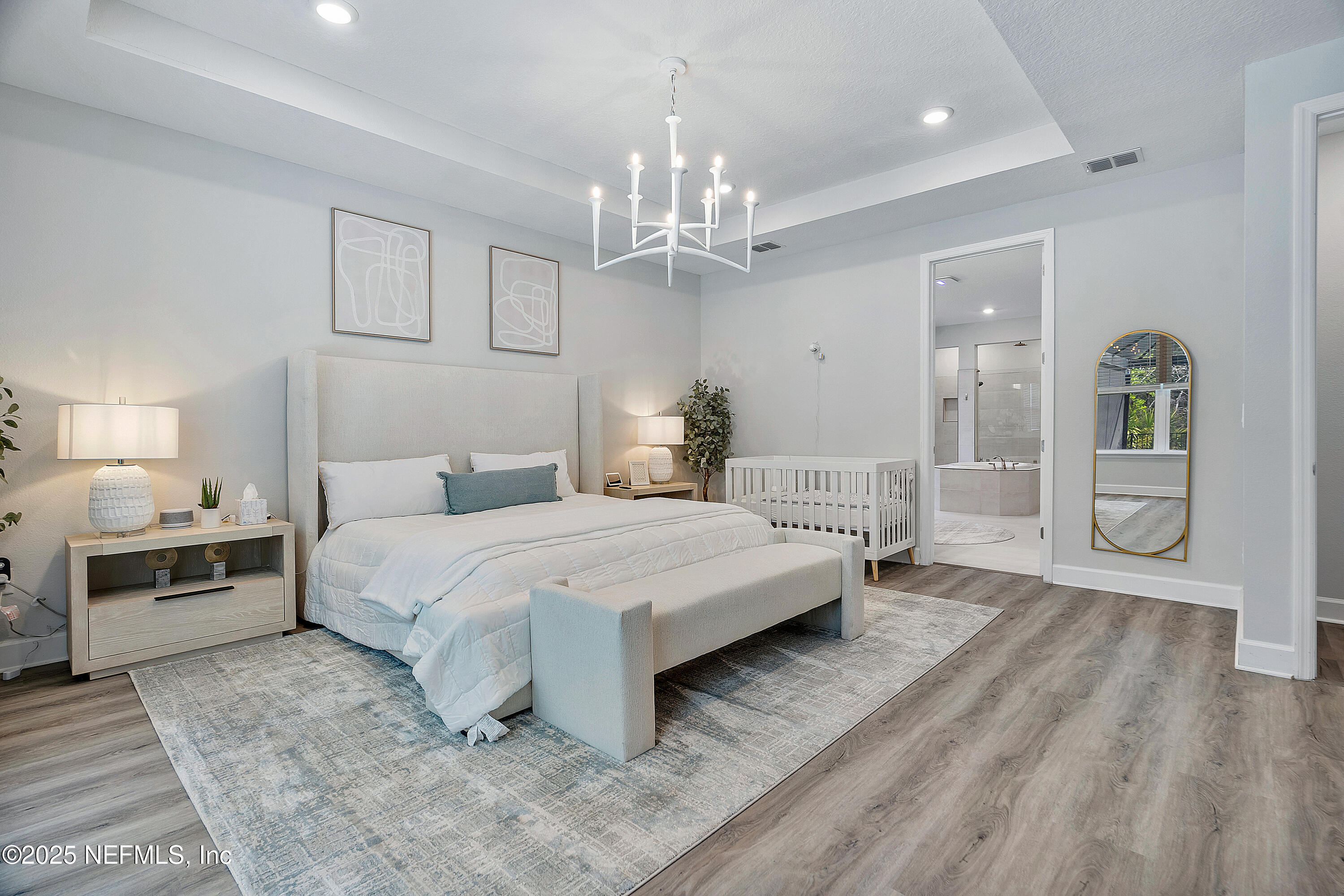 290 Marquesa Circle St. Johns, FL 32259 - Photo 43 of 107 a spacious bedroom with a bed and a chandelier