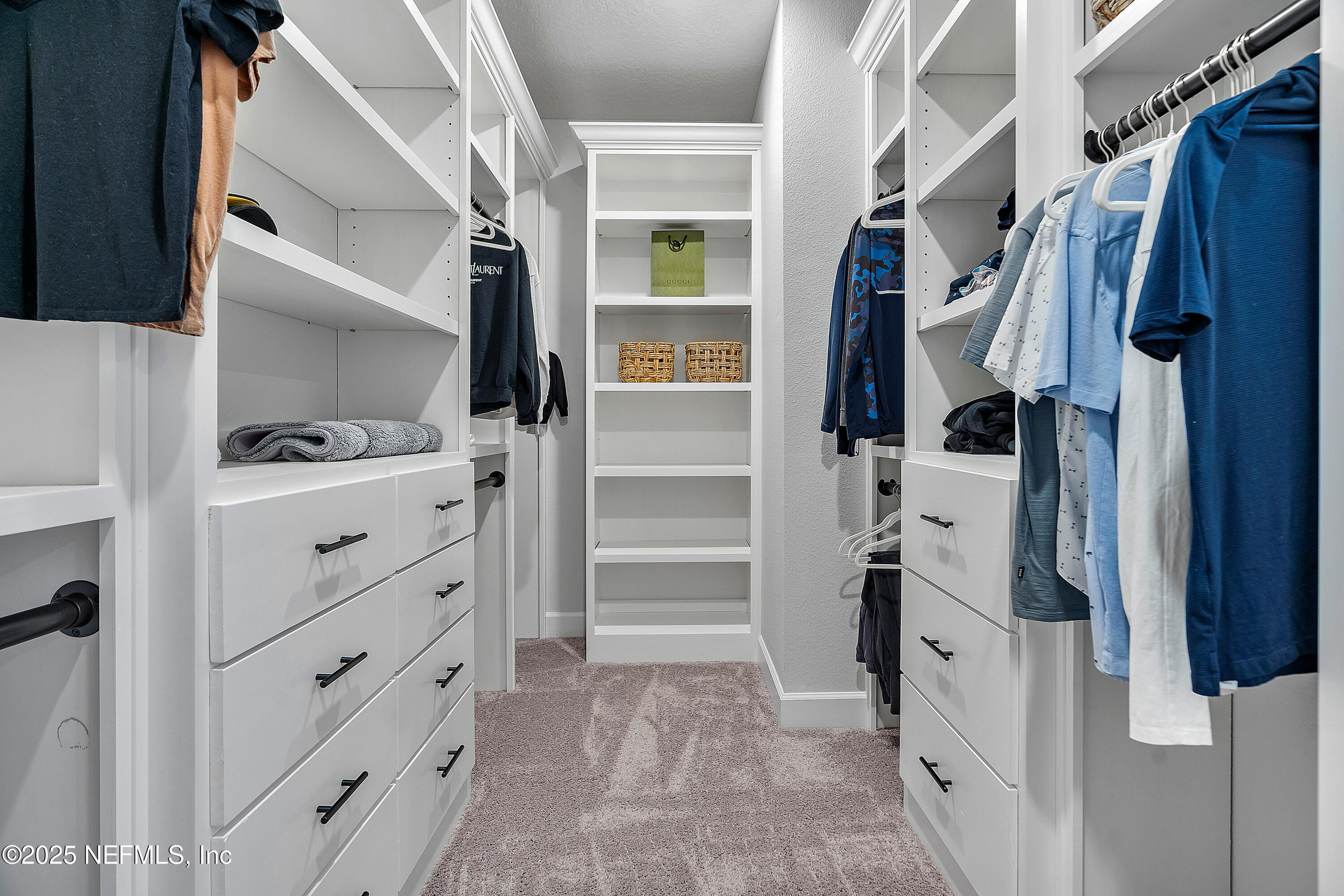 290 Marquesa Circle St. Johns, FL 32259 - Photo 49 of 107 a view of walk in closet with clothes and shoes