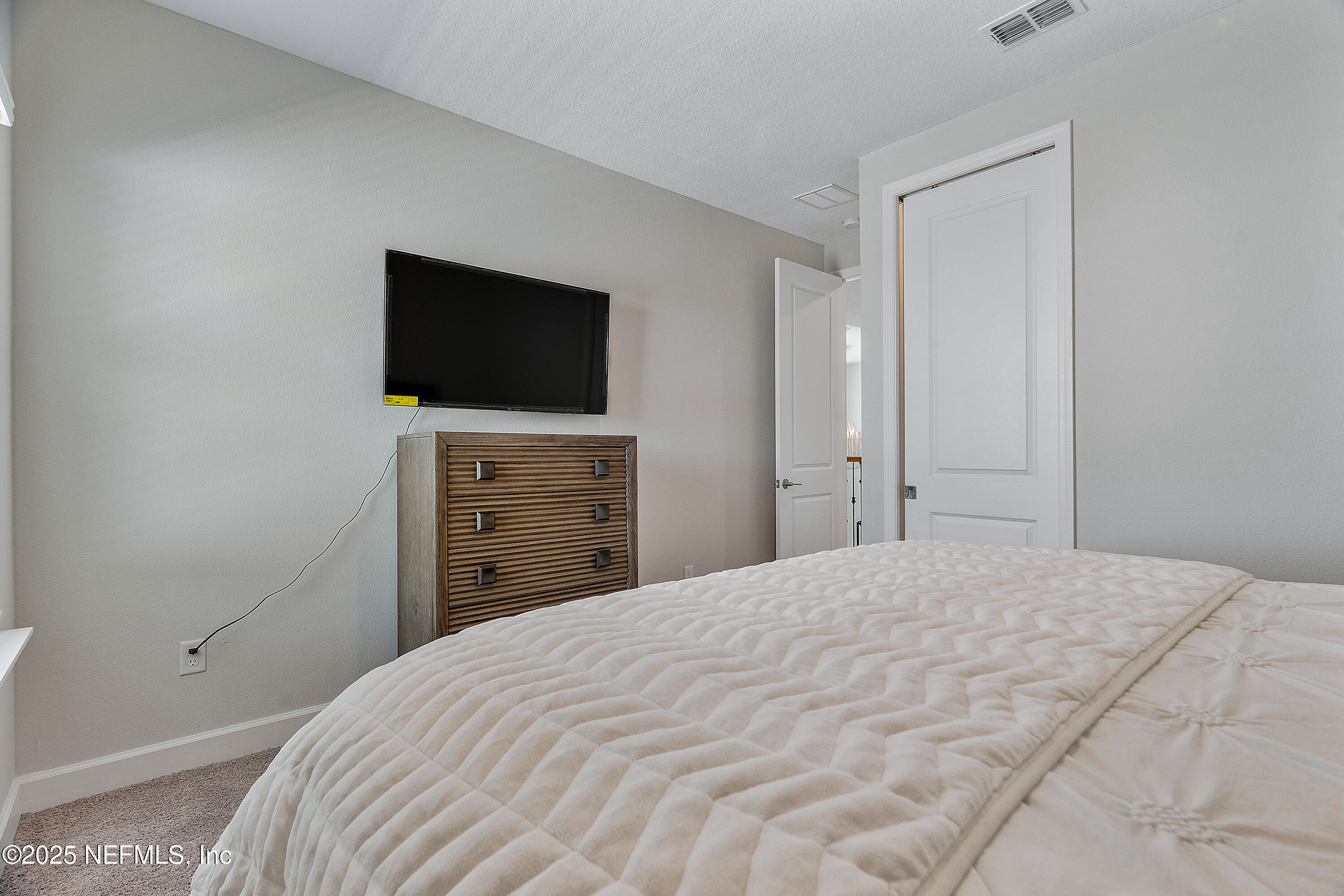 290 Marquesa Circle St. Johns, FL 32259 - Photo 57 of 107 a bedroom with a bed and a flat screen tv