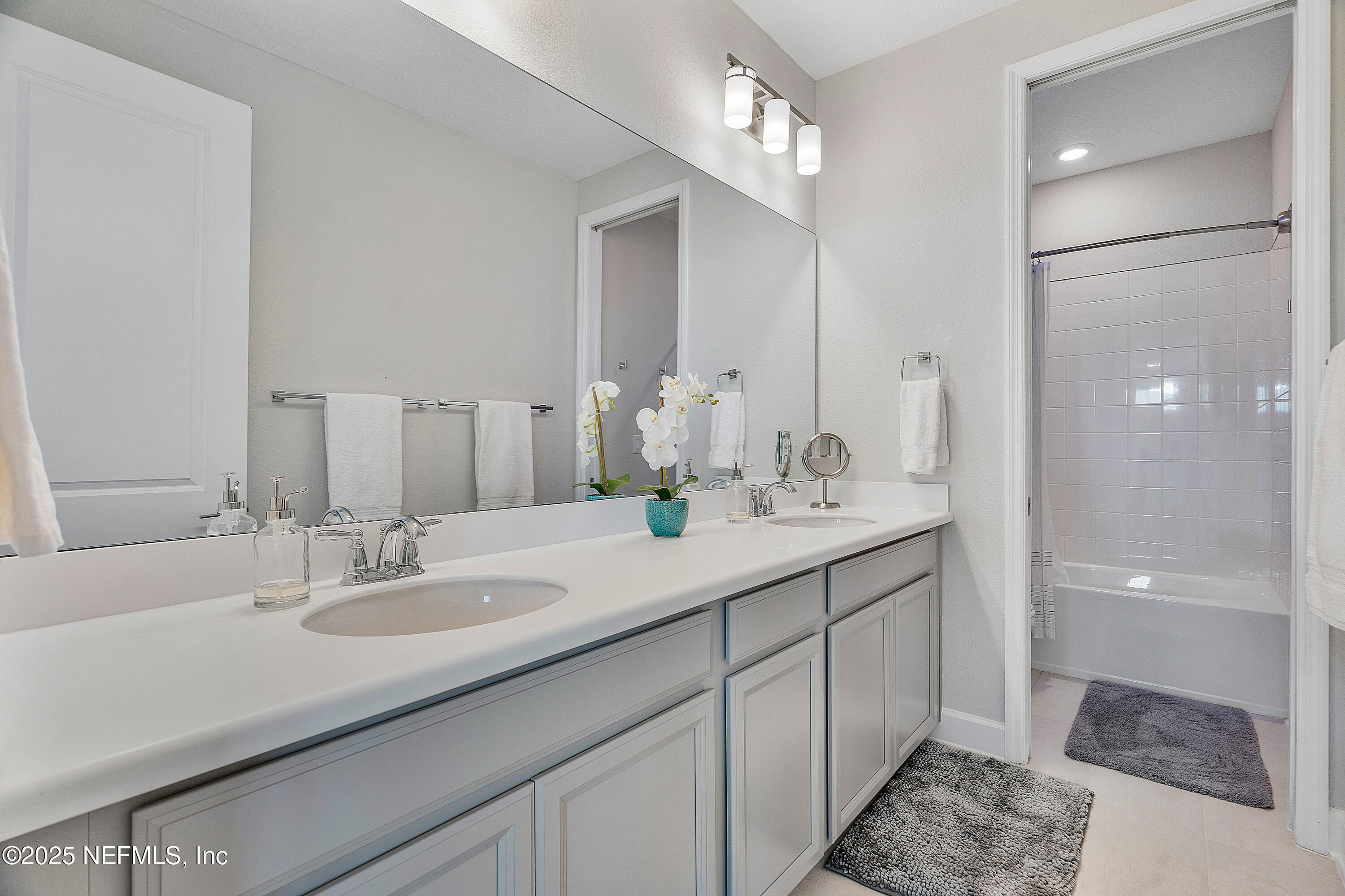 290 Marquesa Circle St. Johns, FL 32259 - Photo 58 of 107 a bathroom with a sink double vanity granite tub shower and a mirror