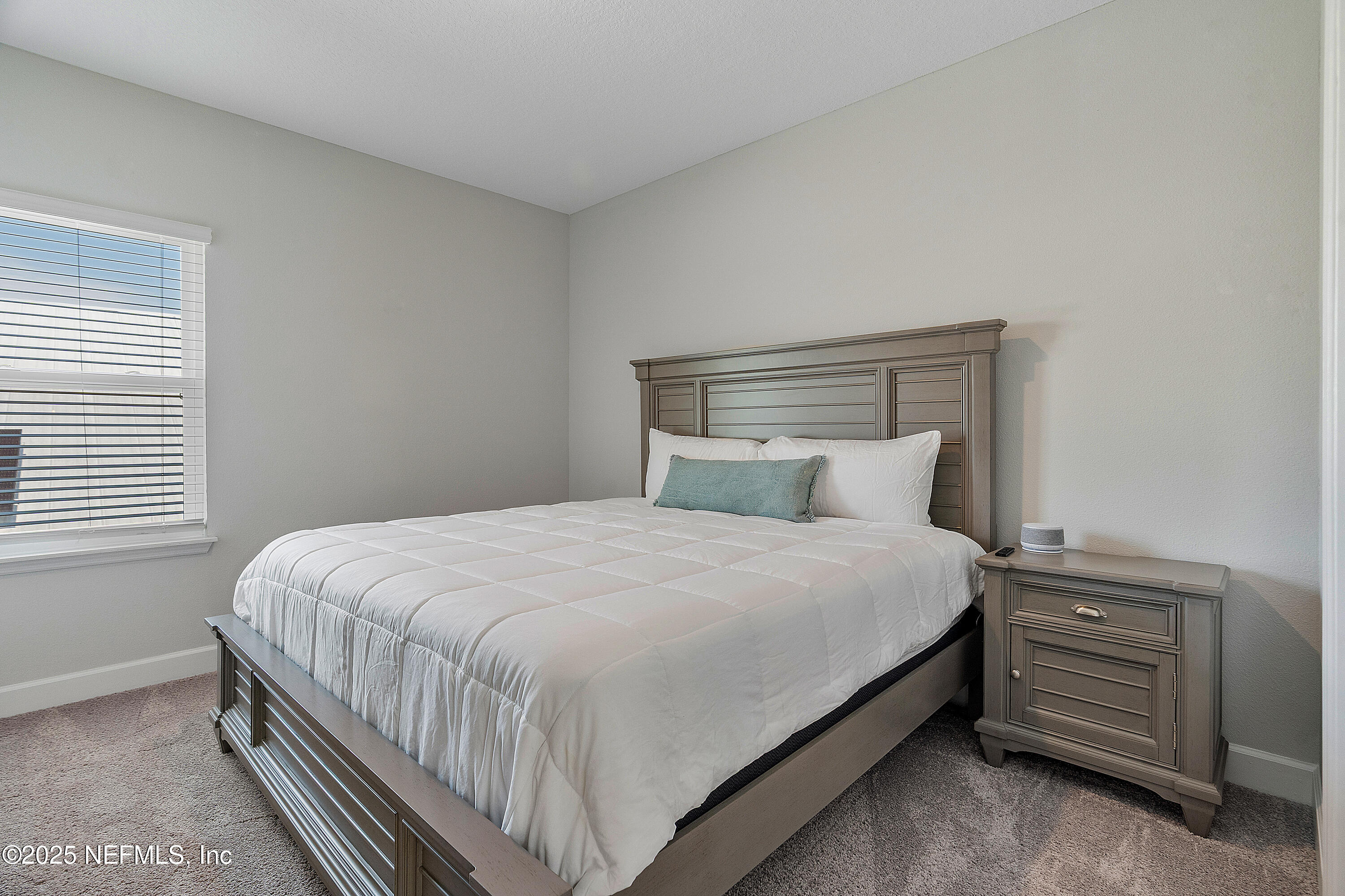 290 Marquesa Circle St. Johns, FL 32259 - Photo 59 of 107 a bed sitting in a bedroom next to a window