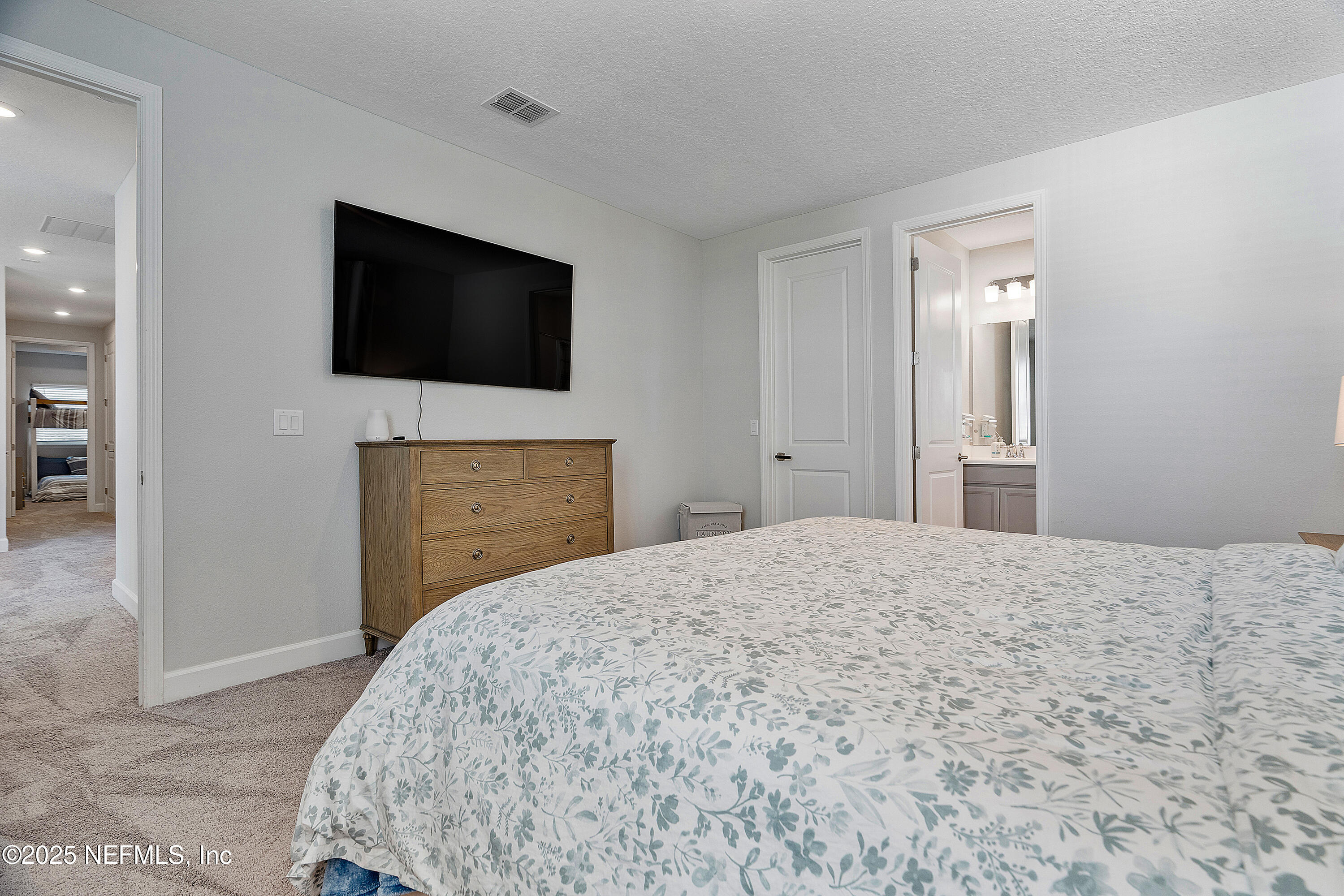 290 Marquesa Circle St. Johns, FL 32259 - Photo 62 of 107 a bedroom with a bed and a flat screen tv