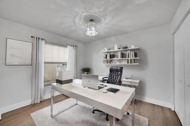 a view of a workspace with furniture and a table