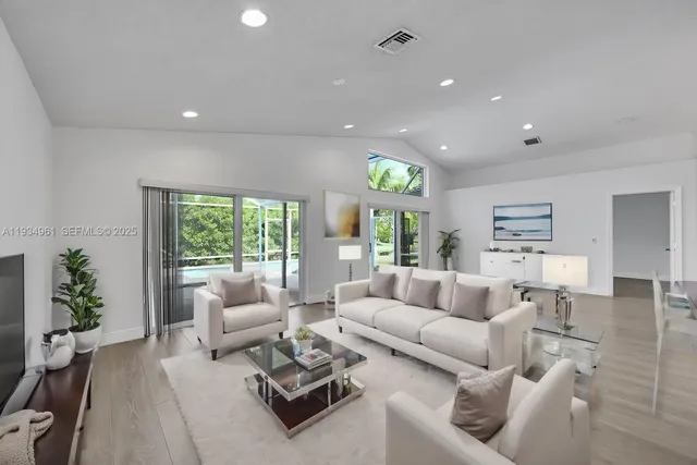 a living room with furniture ceiling fan and a window