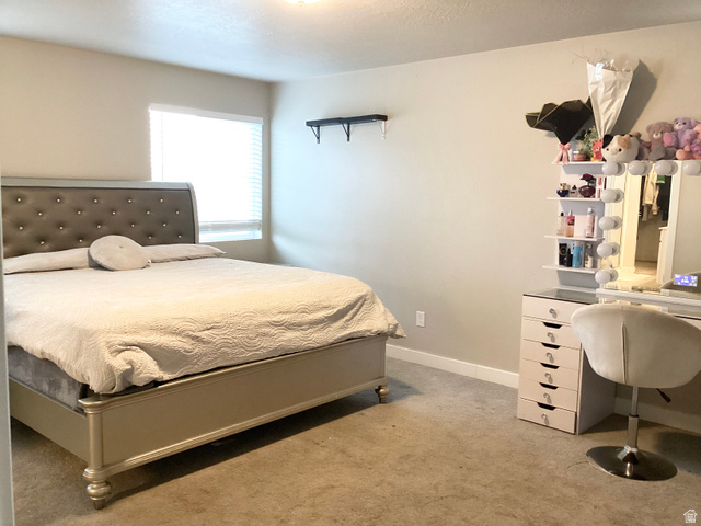 3071 Slate Rock Road Magna, UT 84044 - Photo 10 of 24 Carpeted bedroom with a window featuring blinds and light-toned walls