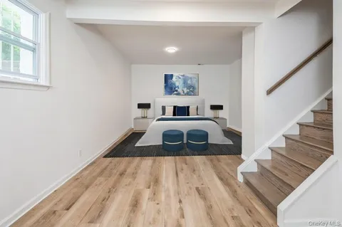 a bedroom with a bed and a painting on the wall