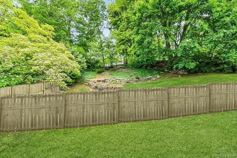 a view of a backyard with wooden fence