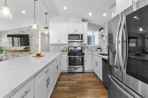 a kitchen with stainless steel appliances a refrigerator sink and stove