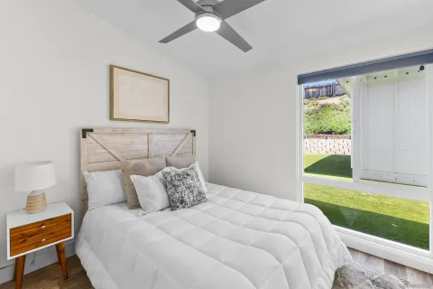 a bedroom with a bed and a window