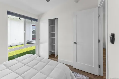 a bedroom with a bed and a large window