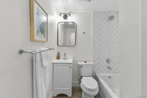 a white toilet sitting next to a bathroom sink