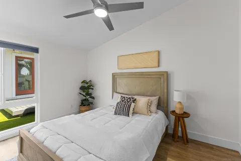 a bedroom with a bed and wooden floor