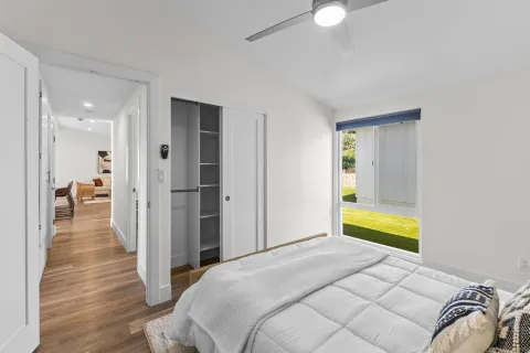 a bedroom with a bed and a window