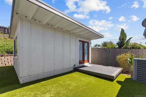 a backyard of a house with table and chairs