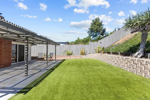 a view of a house with backyard and sitting area