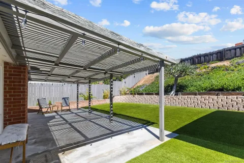 a view of a backyard with sitting area