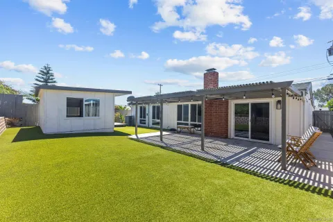 a view of a house with swimming pool and sitting area