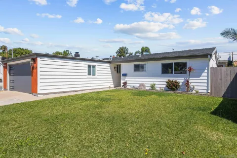 a front view of house with yard and outdoor seating