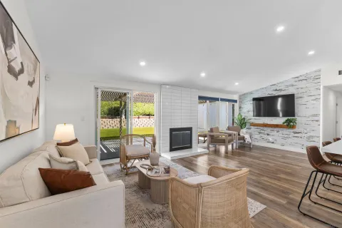 a living room with fireplace furniture and a flat screen tv