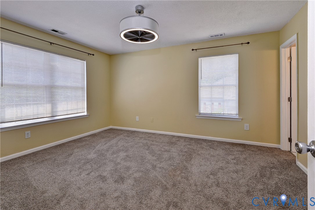 5912 Allegheny Road Williamsburg, VA 23188 - Photo 18 of 38 Large Primary Bedroom with ensuite bathroom and WI