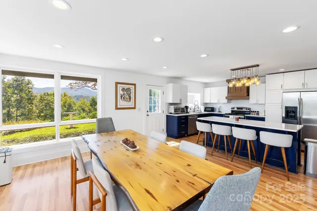 a living room with stainless steel appliances kitchen island granite countertop furniture and a kitchen view