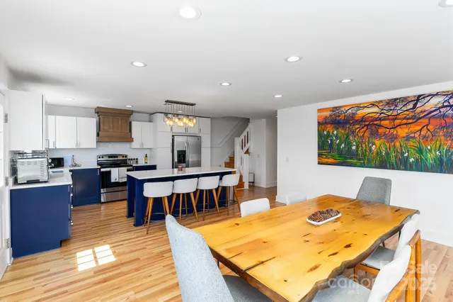 a living room with dining room and wooden floor