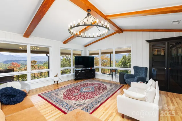 a living room with furniture a rug and a flat screen tv