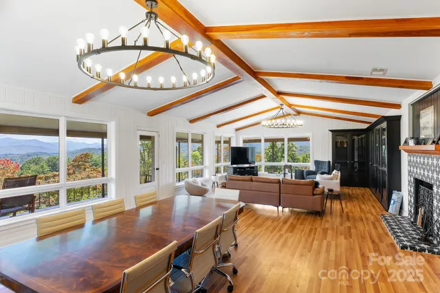 a view of a dining room with furniture a chandelier and wooden floor