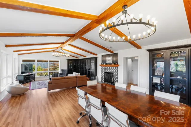 a living room with fireplace furniture and a large window