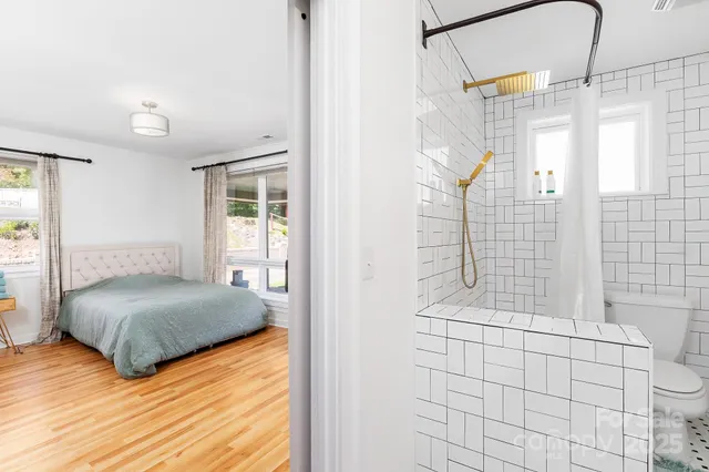 a bedroom with a bed and a shower