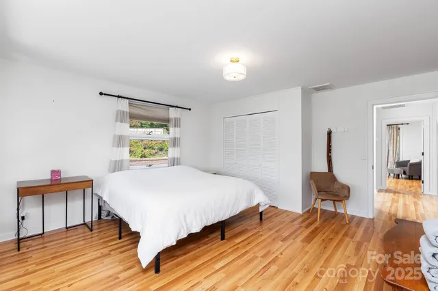 a bed room with a bed and a chair