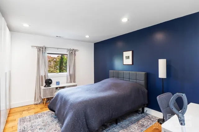 a bedroom with a bed and a large window