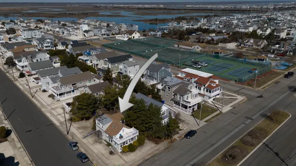 an aerial view of a house with a yard