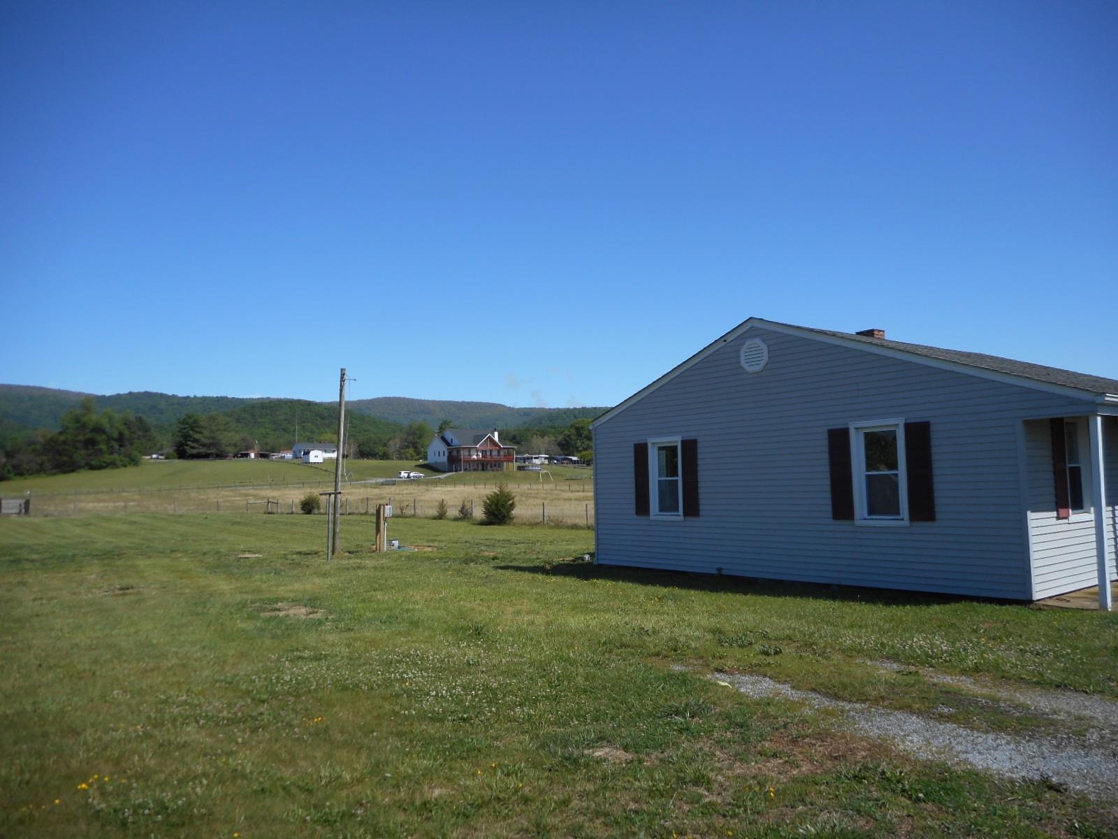 18874 Huckleberry Road Elkton, VA 22827 - Photo 8 of 23 a backyard of a house with table and chairs