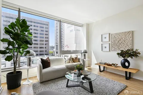 a living room with furniture potted plant and a window