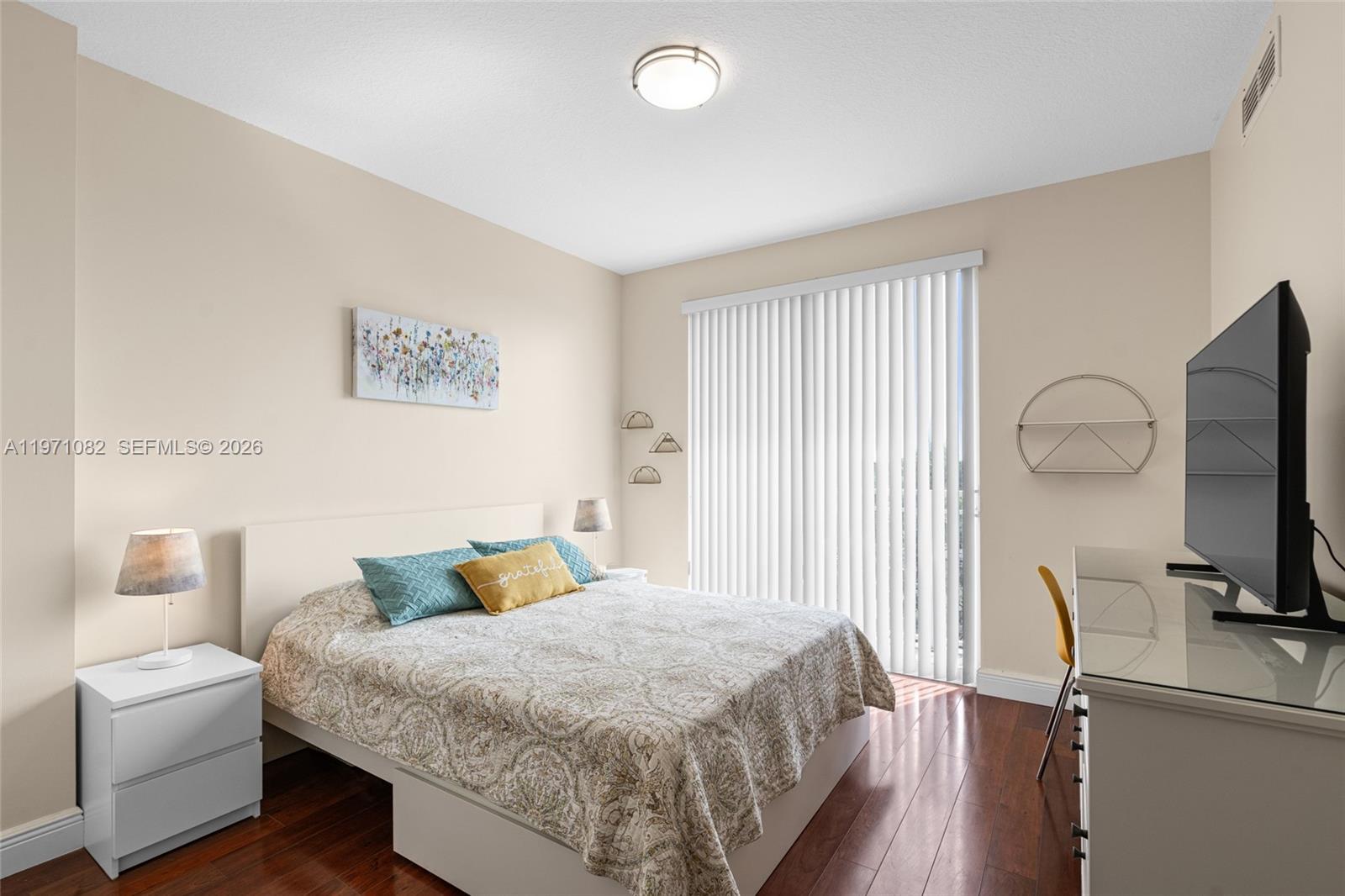 7275 Southwest 90th Way, Unit 404 Miami, FL 33156 - Photo 18 of 35 a bedroom with a bed and wooden floor