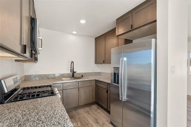 a kitchen with a sink stainless steel appliances and cabinets
