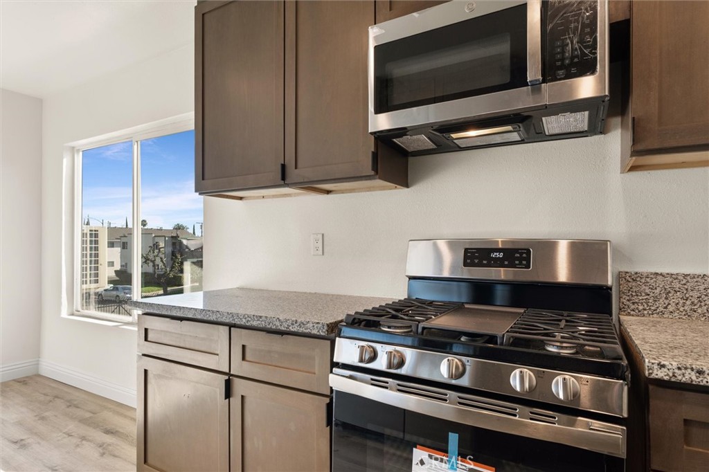 19237 Bryant Street, Unit 16 Northridge, CA 91324 - Photo 7 of 15 a kitchen with a stove and a microwave