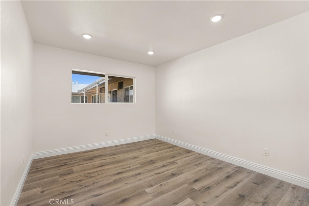 19237 Bryant Street, Unit 16 Northridge, CA 91324 - Photo 8 of 15 a view of empty room with wooden floor