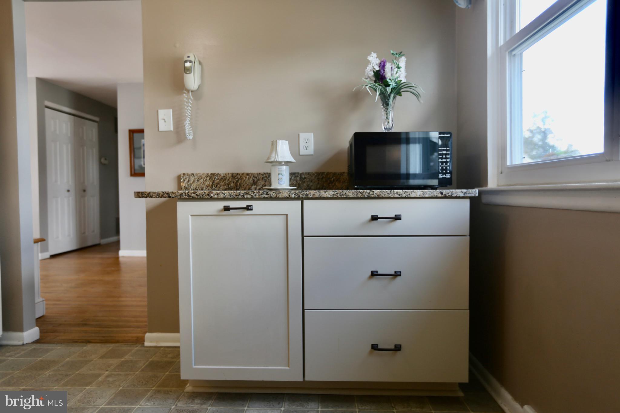 242 Tilford Road Somerdale, NJ 08083 - Photo 12 of 29 a kitchen with stainless steel appliances granite countertop cabinets and a wooden floor
